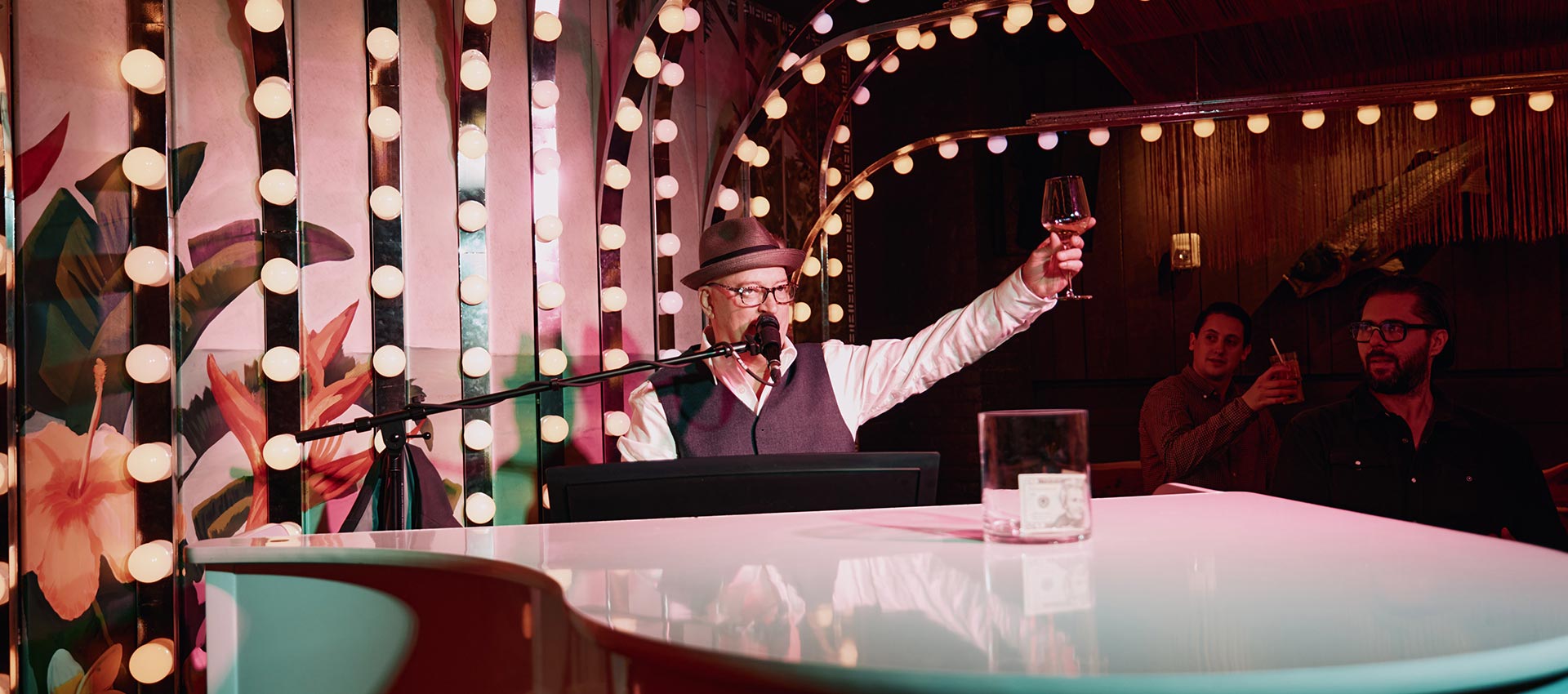 NYC Pianist toasting to the crowd at a Tiki Bar in New York City.