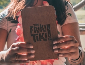 Woman holding The Friki Tiki NYC menu at Tiki Bar in New York City.